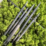 Lightweight carbon fiber awning poles supporting a camping tent.