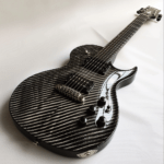 Comparison of carbon fiber and wooden guitar on stage