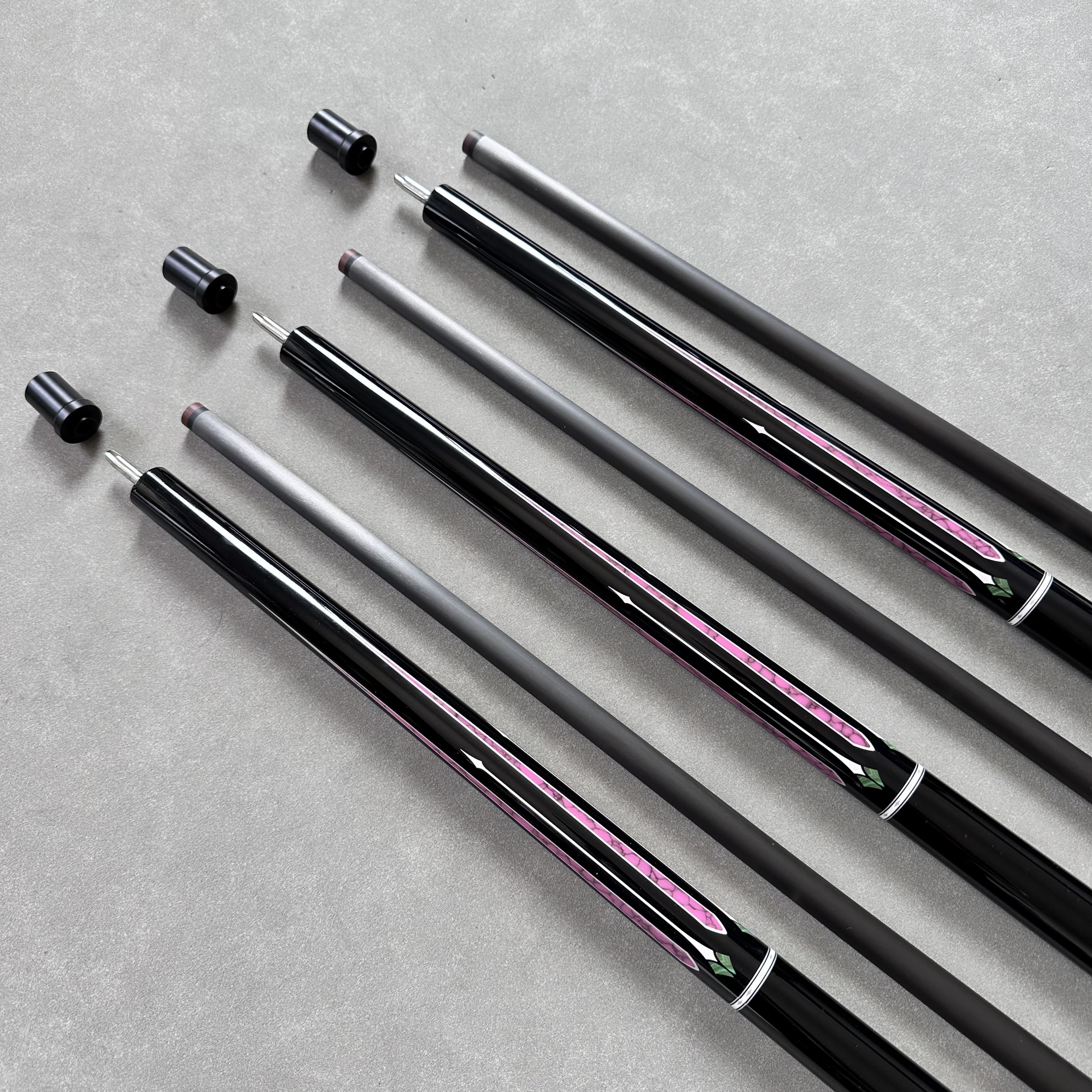 Premium carbon fiber cue shaft held by a professional player