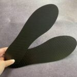 Close-up of a carbon fiber plate embedded in a running shoe