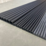 Close-up of carbon fiber rod and steel rod side-by-side