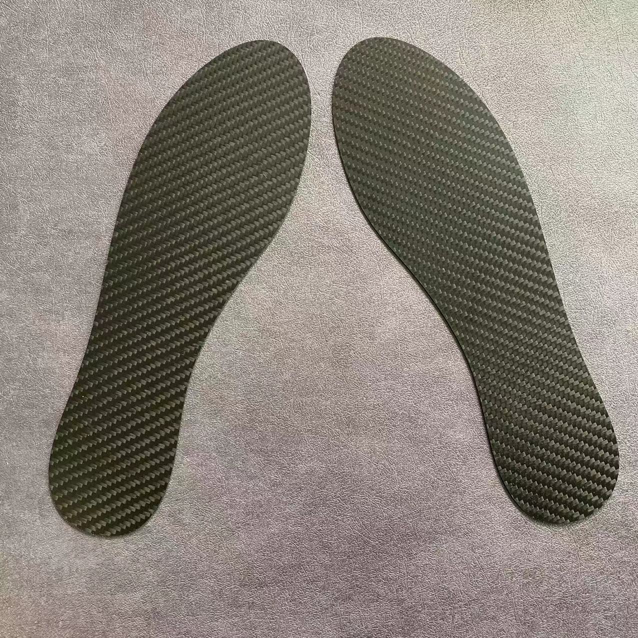 Close-up of carbon fiber foot insoles showcasing their lightweight and durable design.